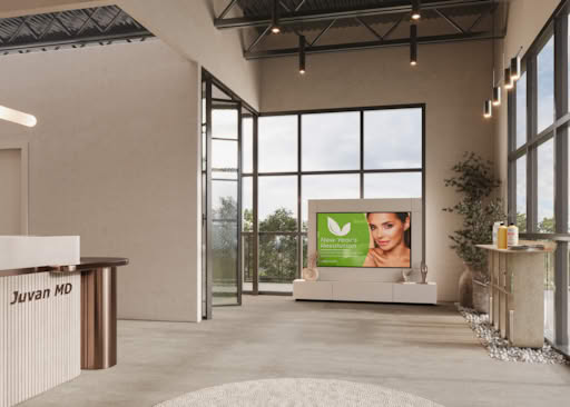 Elegant beauty salon reception with front desk, digital display, large windows, and natural light interior design.