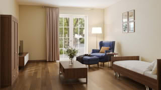 A cozy bedroom with a blue armchair, wooden bed, and sliding glass door leading to garden.