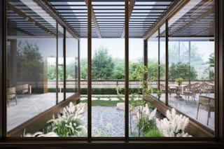 A serene view of a modern cafe with large windows overlooking tranquil garden.