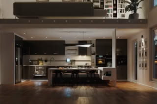 Modern kitchen with black cabinets, white island, and wooden floor.
