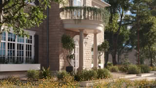 Close-up of Stonehaven Manor’s rounded stone balcony with columns, hanging greenery, and luxury architectural details.