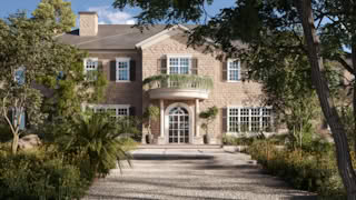 Elegant entrance of Stonehaven Manor in the USA with a round stone balcony, double columns, and landscaped pathway.
