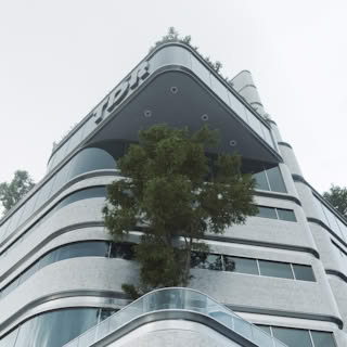 Close-up of TDR Tower upper floors with curved glass balconies, greenery, and modern architectural lines.