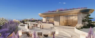 A modern rooftop garden with lavender plants and sleek furniture under a clear blue sky.
