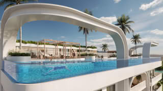 A modern residential building complex features a curved roof and large swimming pool with people enjoying the.