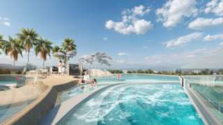 A family enjoys a relaxing day at luxurious rooftop pool with palm trees and scenic view.